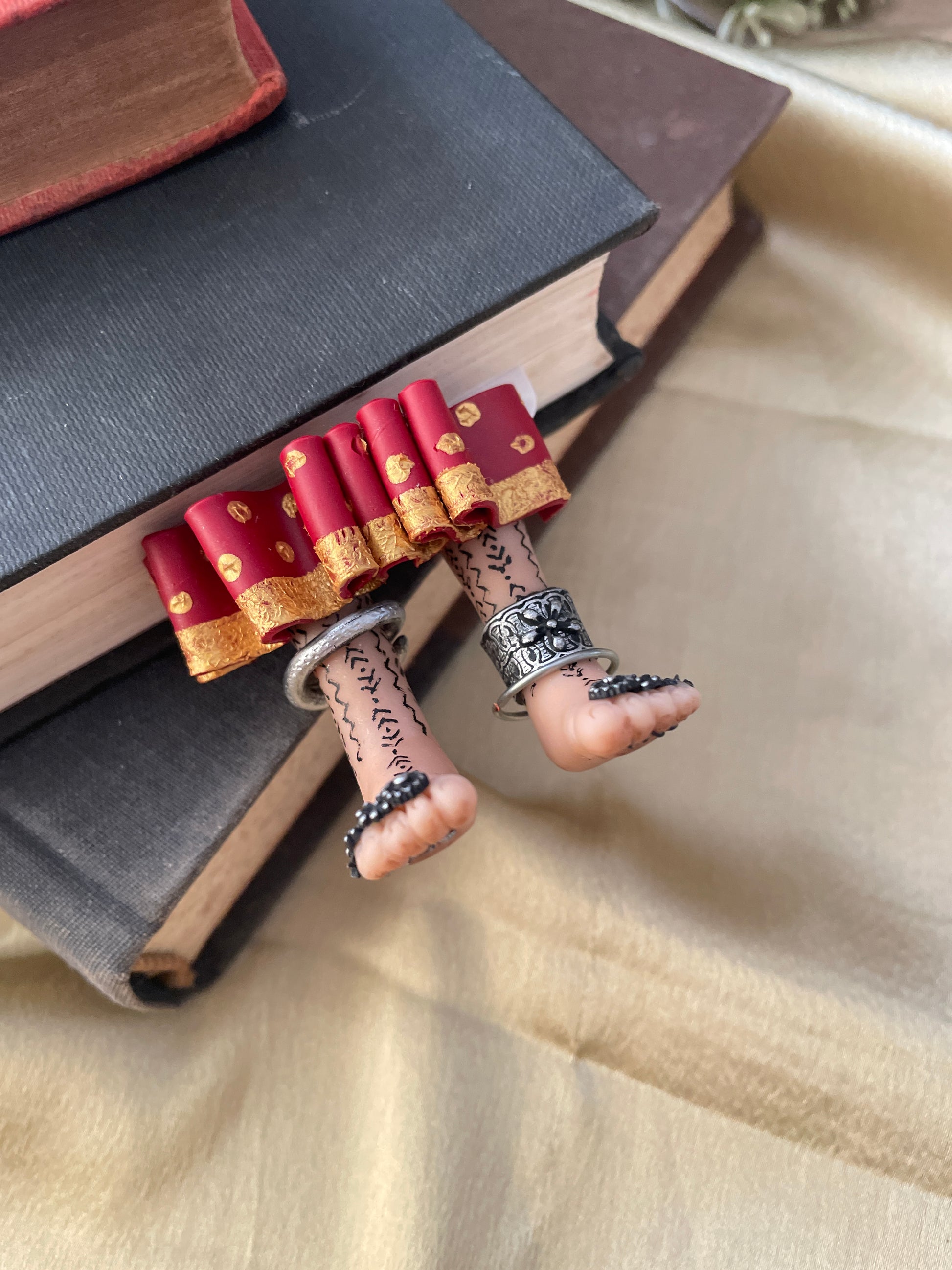 Tribal legs with maroon skirt and oxidized jewellery ,attached to a bookmark  that says find you tribe love them hard